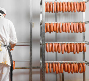 Sausage hanging at meat processing facility.